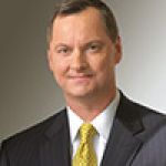 A professional headshot of a man.