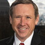 A professional headshot of a man.