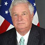 A professional headshot of a man.