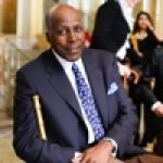 A professional headshot of a man.