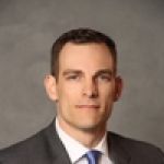 A professional headshot of a man.