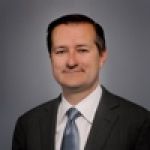 A professional headshot of a man.