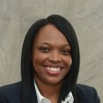 A professional headshot of a woman.