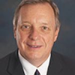 A professional headshot of a man.