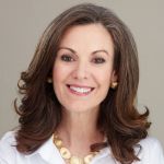 A professional headshot of a woman.