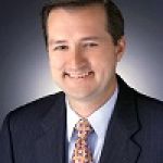 A professional headshot of a man.