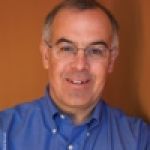 A professional headshot of a man.