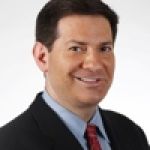 A professional headshot of a man.