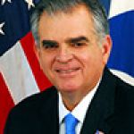 A professional headshot of a man.