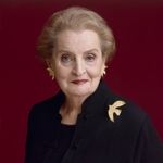 A professional headshot of a woman.