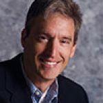 A professional headshot of a man.