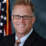 A professional headshot of a man.