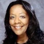 A professional headshot of a woman.