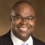 A professional headshot of a man.