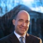 A professional headshot of a man.