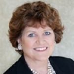 A professional headshot of a woman.