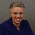 A professional headshot of a woman.