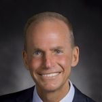 A professional headshot of a man.