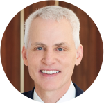 A professional headshot of Mike O'Grady